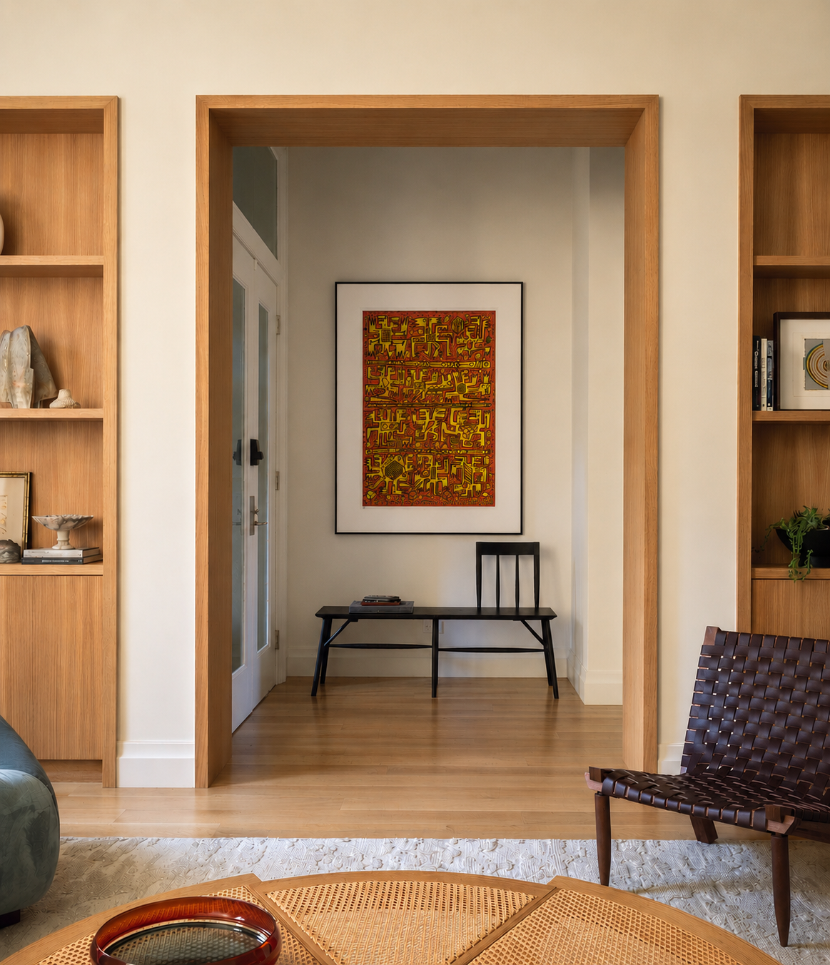 Living room with wooden shelves, a rug, and a painting on the wall.