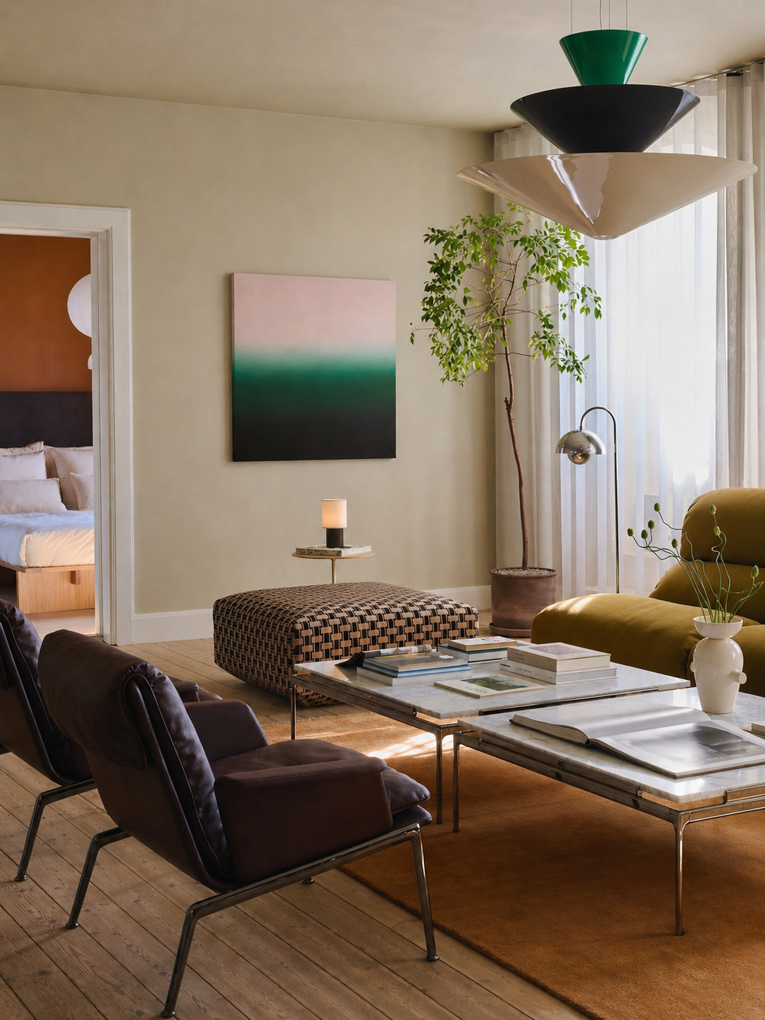 Modern living room with a coffee table, chairs, and contemporary artwork on a wall by welsh artist Elfyn Lewis. 