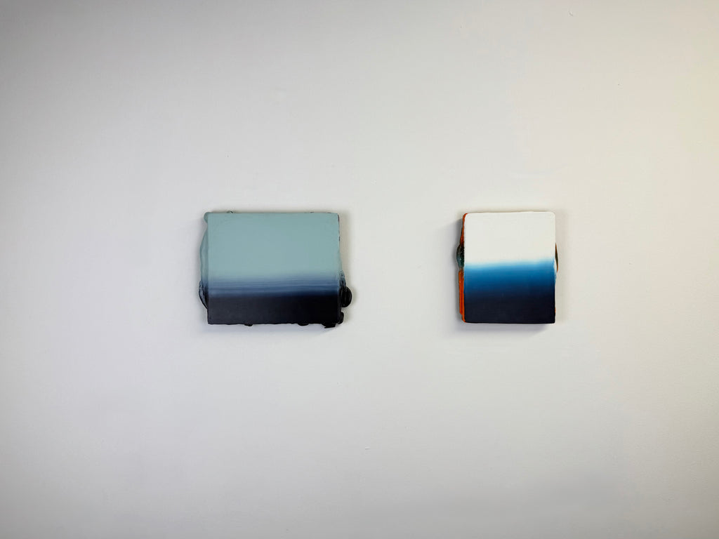 Original minimalist diptych artwork by Welsh Artist Elfyn Lewis. Two Acrylic painting on MDF panels to create a strong visual identity and cohesive art language. The two abstract art pieces reflect the change in a costal setting, from stormy seas of deep indigos to the calmer and serene water of white and light blue palettes. 