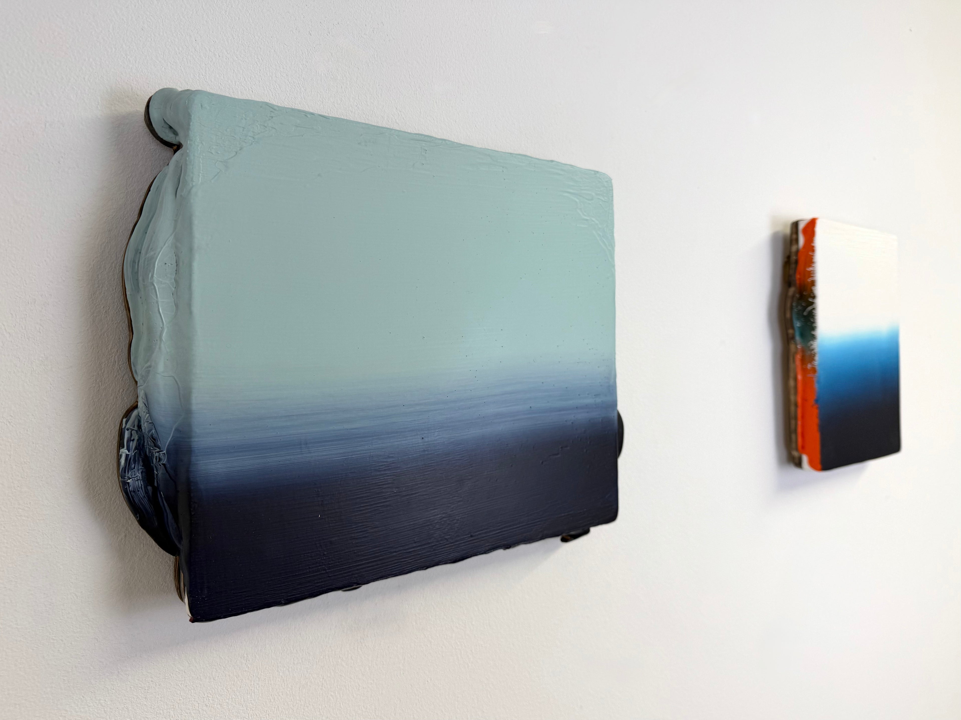 Original minimalist diptych artwork by Welsh Artist Elfyn Lewis. Two Acrylic painting on MDF panels to create a strong visual identity and cohesive art language. The two abstract art pieces reflect the change in a costal setting, from stormy seas of deep indigos to the calmer and serene water of white and light blue palettes. 