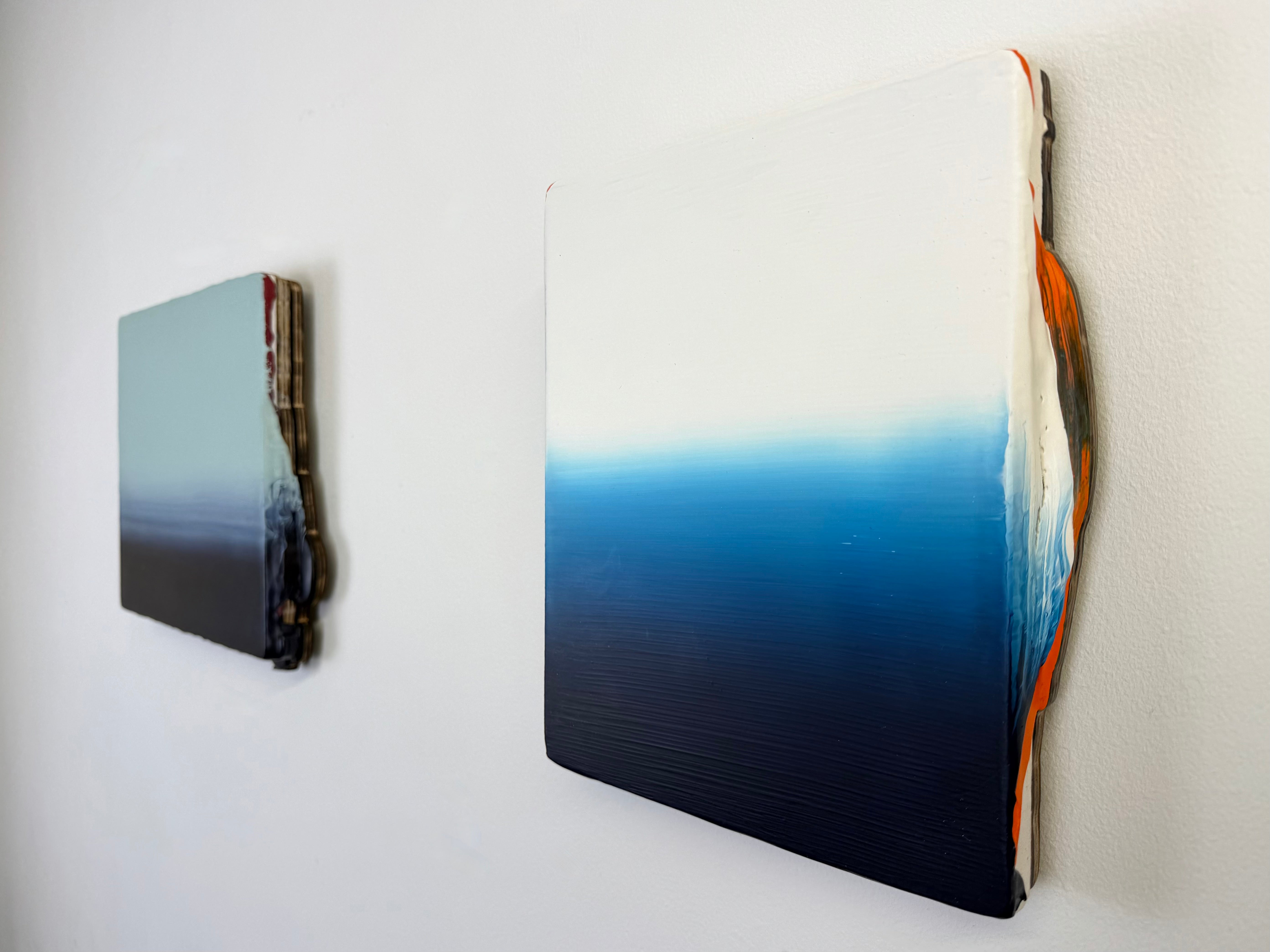 Original minimalist diptych artwork by Welsh Artist Elfyn Lewis. Two Acrylic painting on MDF panels to create a strong visual identity and cohesive art language. The two abstract art pieces reflect the change in a costal setting, from stormy seas of deep indigos to the calmer and serene water of white and light blue palettes. 