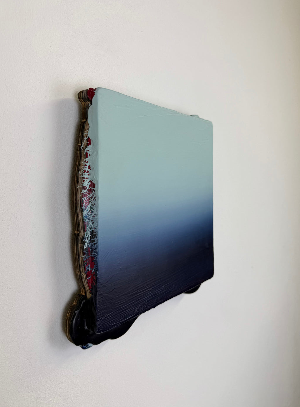 Original minimalist artwork by Welsh Artist Elfyn Lewis. Acrylic paint on MDF board to create a 3D effect with a calming yet striking appearance. An abstract landscape piece inspired by a glacial landscape, with colours of light blue transitioning into deep midnight blue and beyond. 
