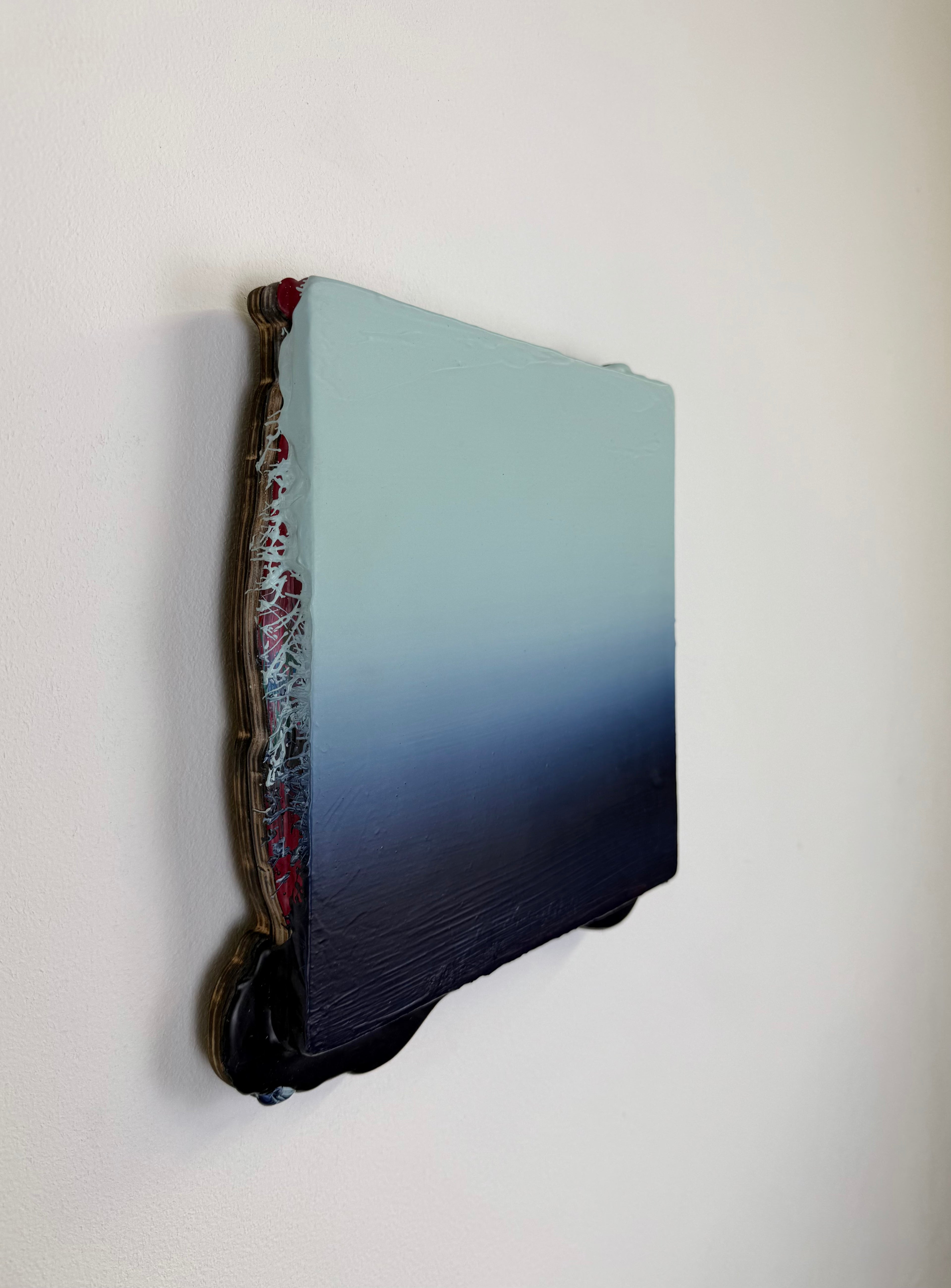 Original minimalist artwork by Welsh Artist Elfyn Lewis. Acrylic paint on MDF board to create a 3D effect with a calming yet striking appearance. An abstract landscape piece inspired by a glacial landscape, with colours of light blue transitioning into deep midnight blue and beyond. 
