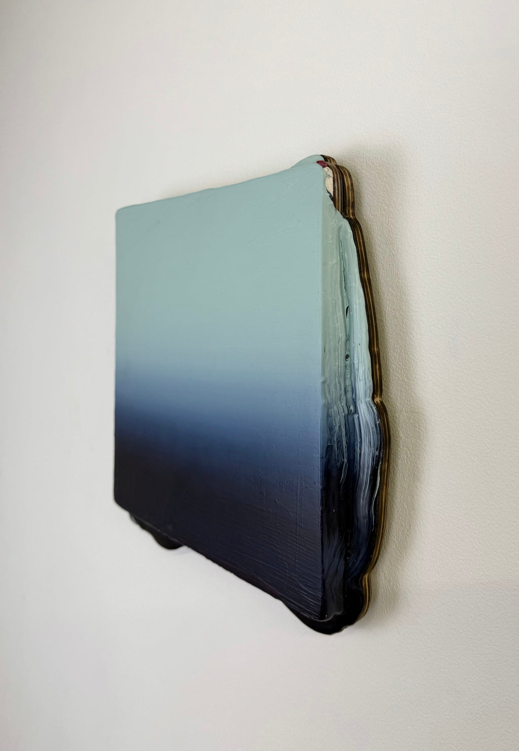 Original minimalist artwork by Welsh Artist Elfyn Lewis. Acrylic paint on MDF board to create a 3D effect with a calming yet striking appearance. An abstract landscape piece inspired by a glacial landscape, with colours of light blue transitioning into deep midnight blue and beyond. 
