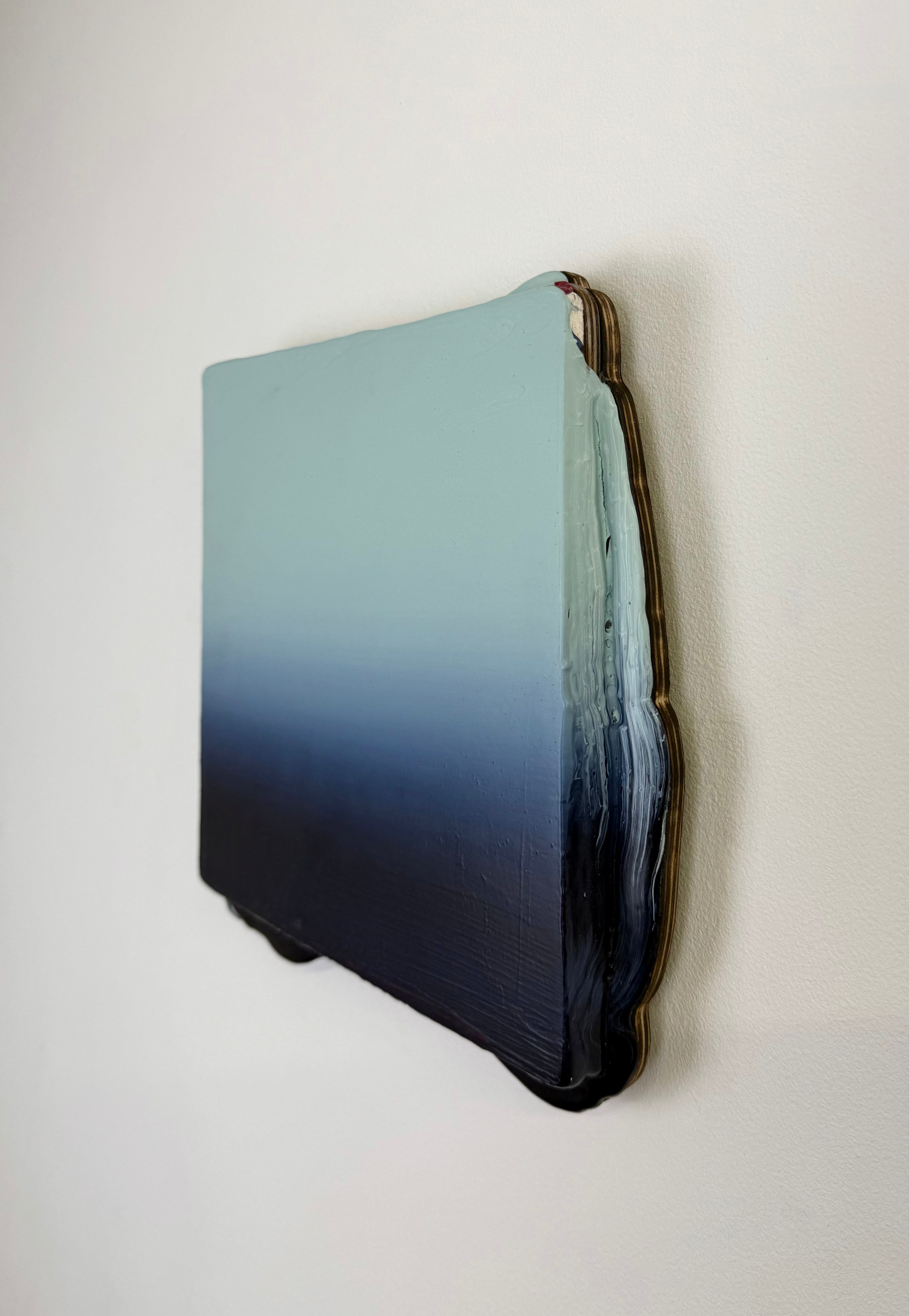 Original minimalist artwork by Welsh Artist Elfyn Lewis. Acrylic paint on MDF board to create a 3D effect with a calming yet striking appearance. An abstract landscape piece inspired by a glacial landscape, with colours of light blue transitioning into deep midnight blue and beyond. 