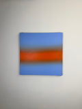 Original minimalist artwork by Welsh Artist Elfyn Lewis. Acrylic paint on MDF board to create a calming yet striking appearance through a dramatic warm orange band, radiating amongst a calm light blue at the top and base, reflecting feelings of a diminishing sunset landscape. 