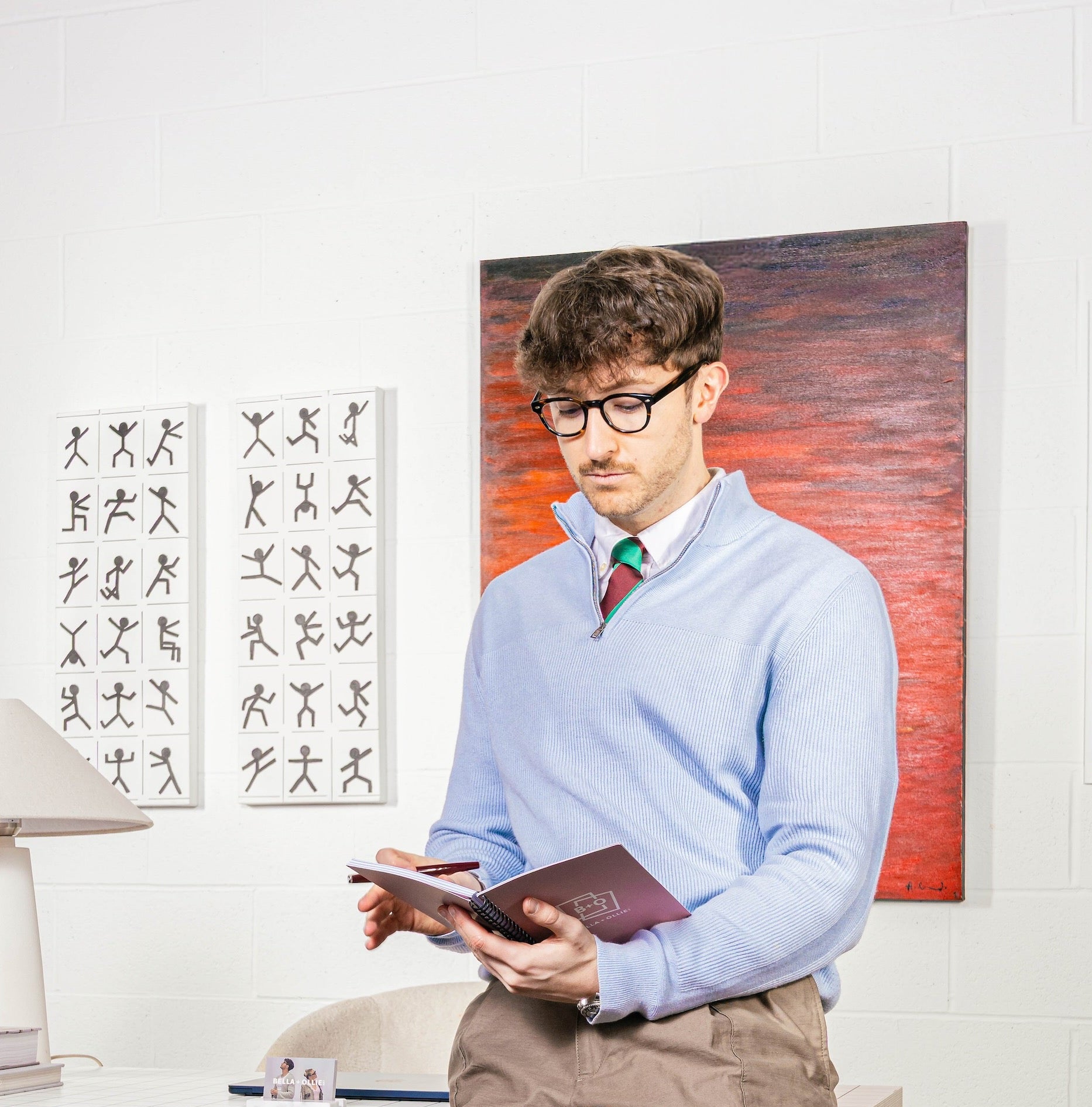 Ollie, founder and expert art curator wearing light blue, In charge of our professional art curation service. 