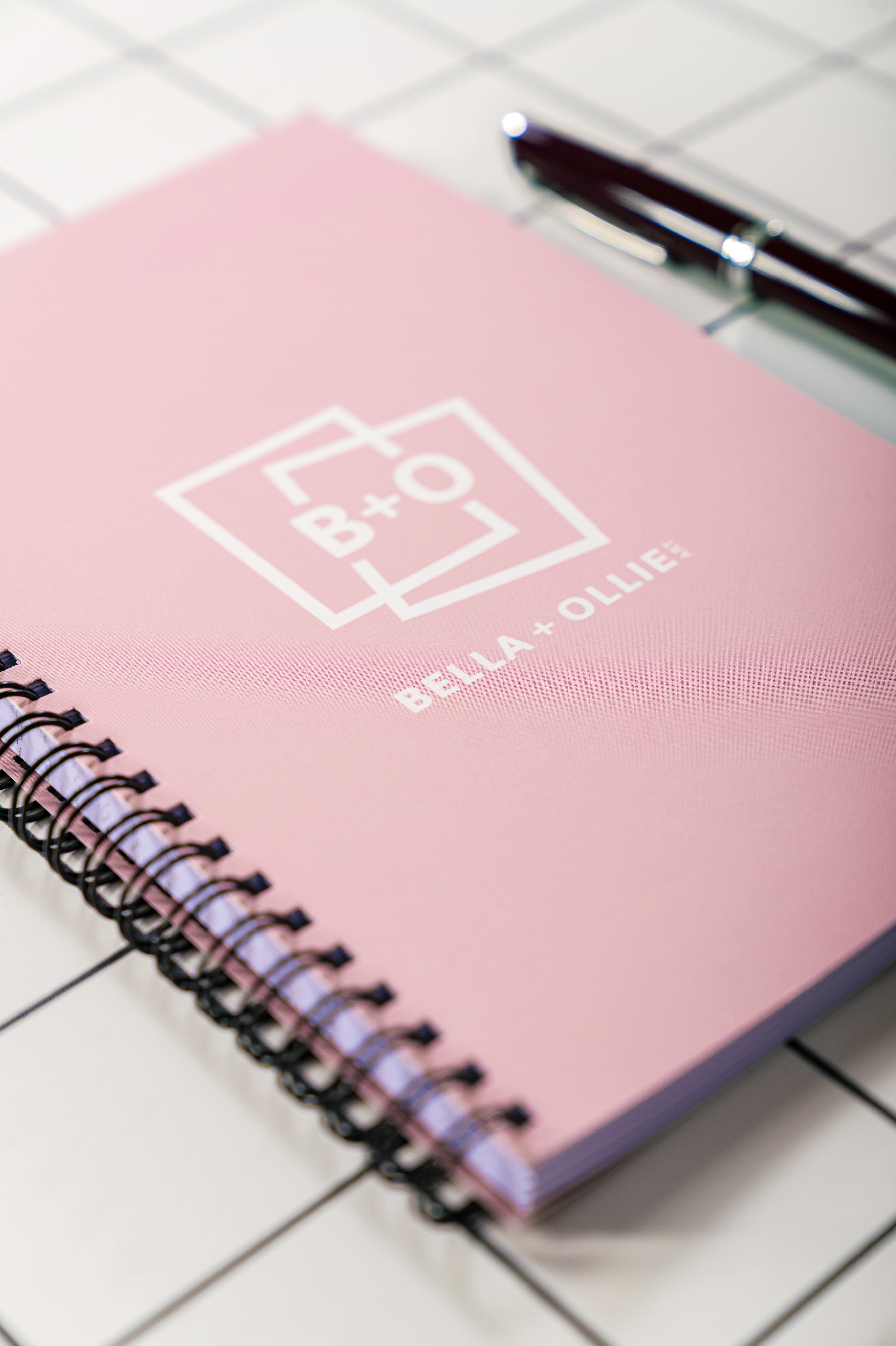 Bella and Ollie Art, specialising in contemporary and abstract art, showing our branded notebook in baby pink for the hero image of our Art Community page.
