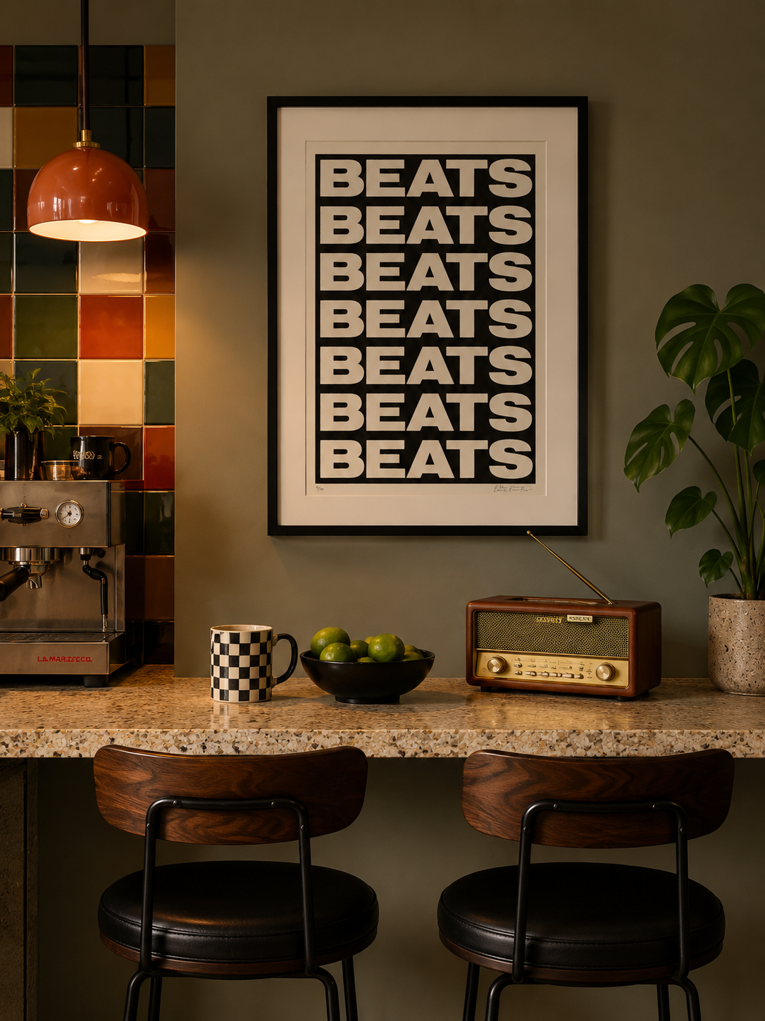 Modern kitchen with 'BEATS' poster, coffee machine, and bar stools.
