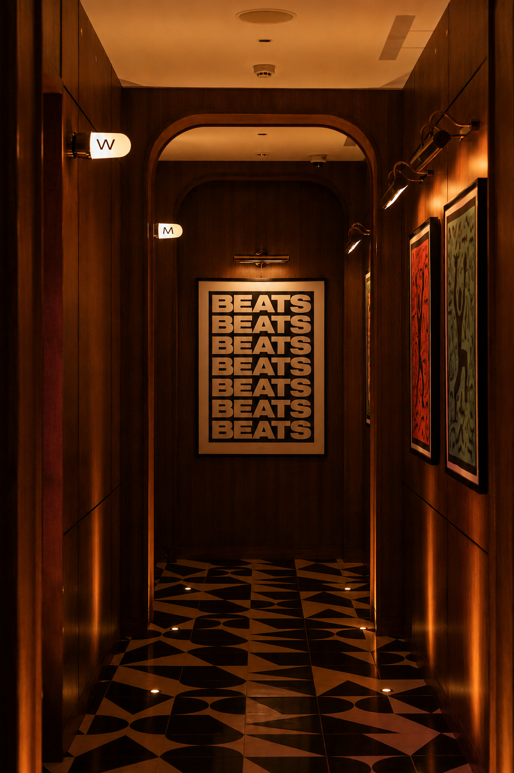  hallway with framed artwork on walls, including a prominent 'BEATS' sign.