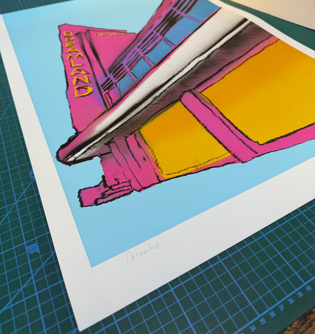 Dreamland Spray by Maximillian Boxer, contemporary Pop Art print featuring the iconic Dreamland Margate building in vibrant pink, yellow and blue spray-painted colours.
