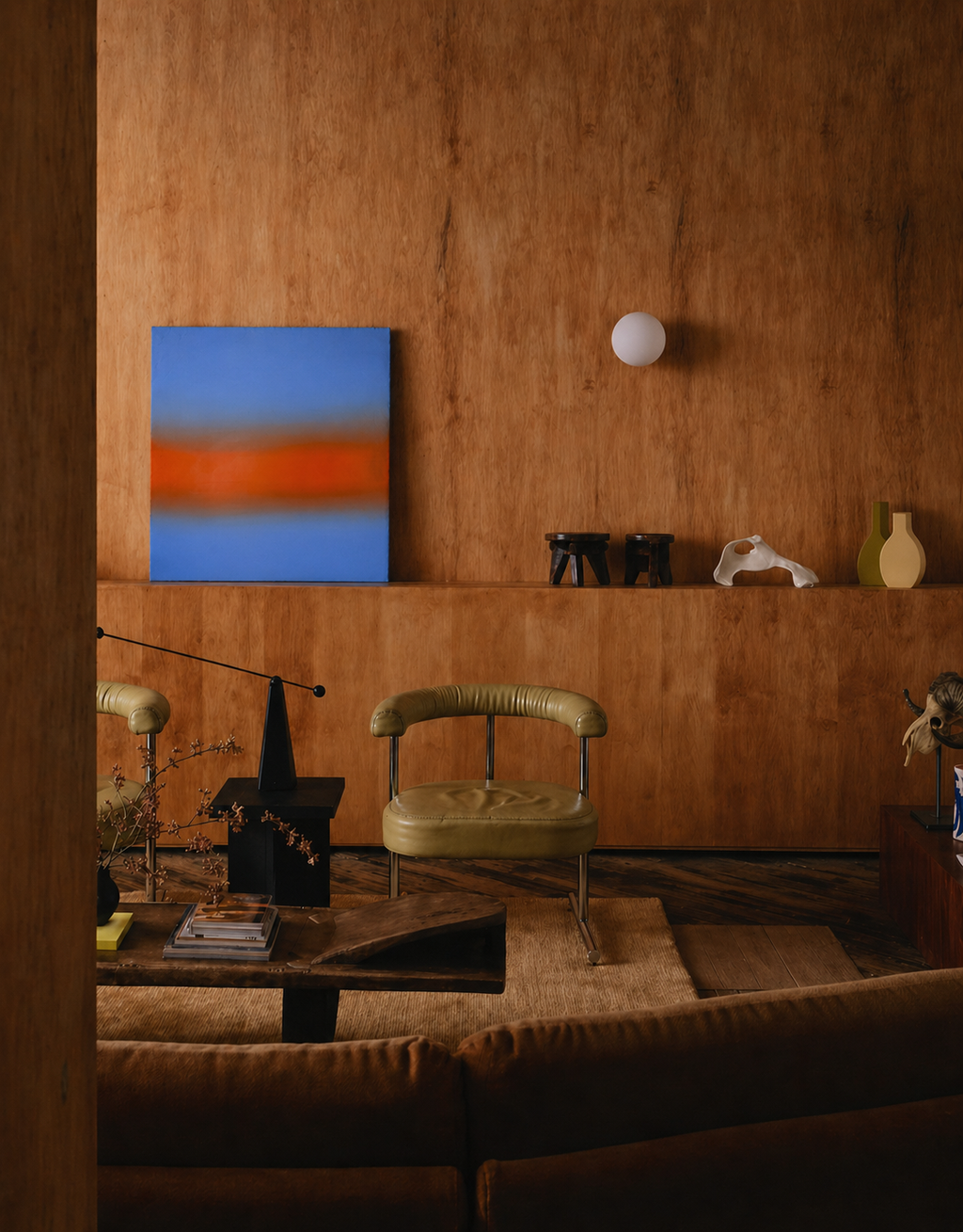 Modern interior with abstract painting, green chair, and wooden wall.
