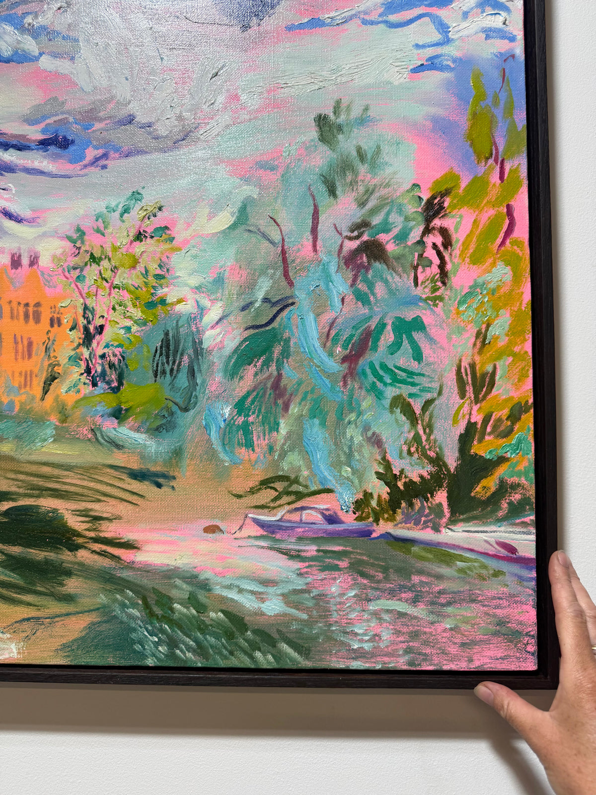 A framed impressionist English landscape painting featuring vibrant greens, pinks, blues, and yellows. The River Carries the Light 2026 by Hannah Rollings, original contemporary landscape painting of the River Thames